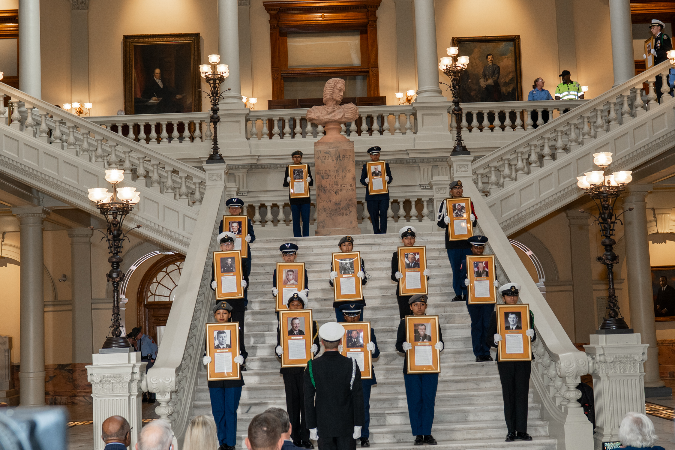 JROTC cadets holding inductee portraits on Capitol stairs